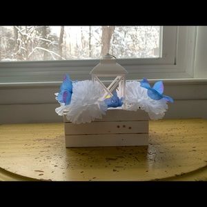 Crate and lantern centerpiece with dark blue flowers